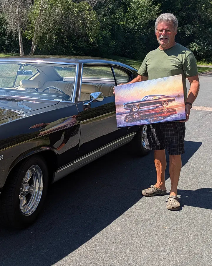 Mike holding his Chevelle canvas next to the real car